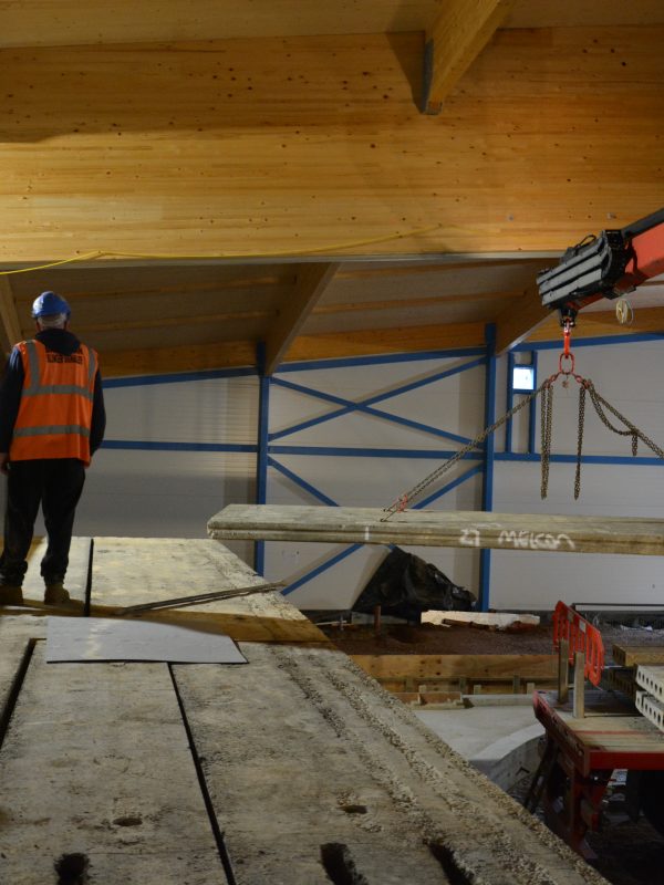 indoor crane lifting hollowcore planks into position