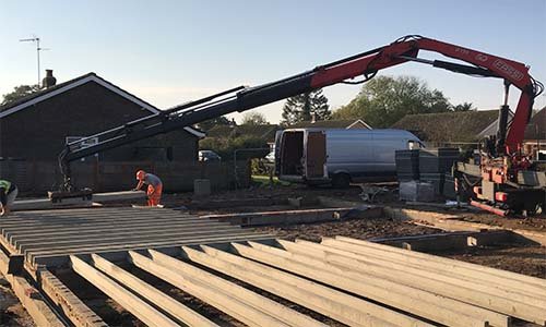 Crane at full reach moving beams